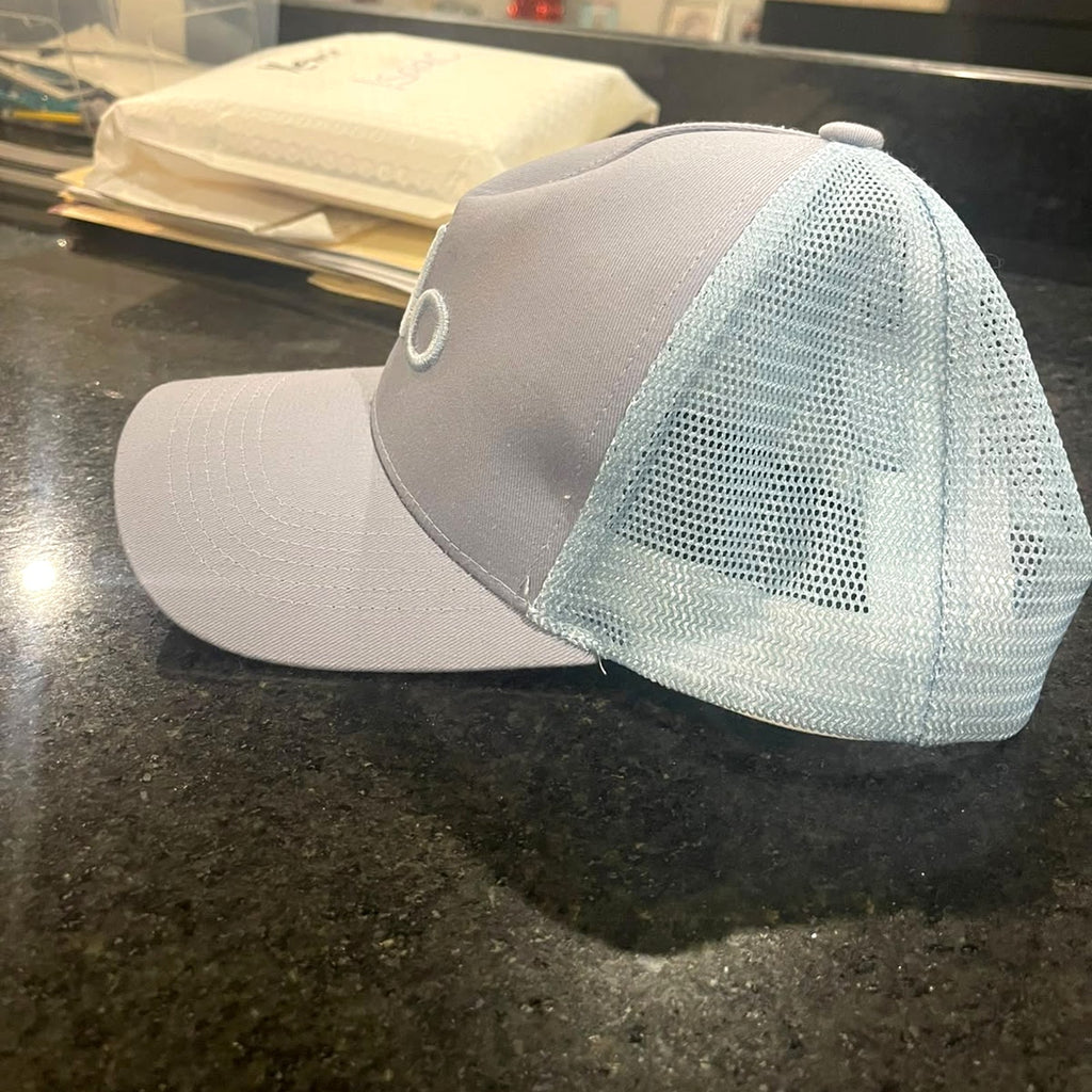 Alo Yoga District Trucker Hat in Sky Blue, side view showing the mesh back – real photo