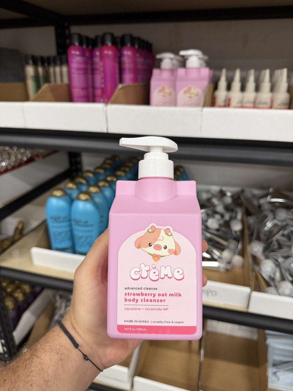 The Crème Shop strawberry body cleanser in hand
