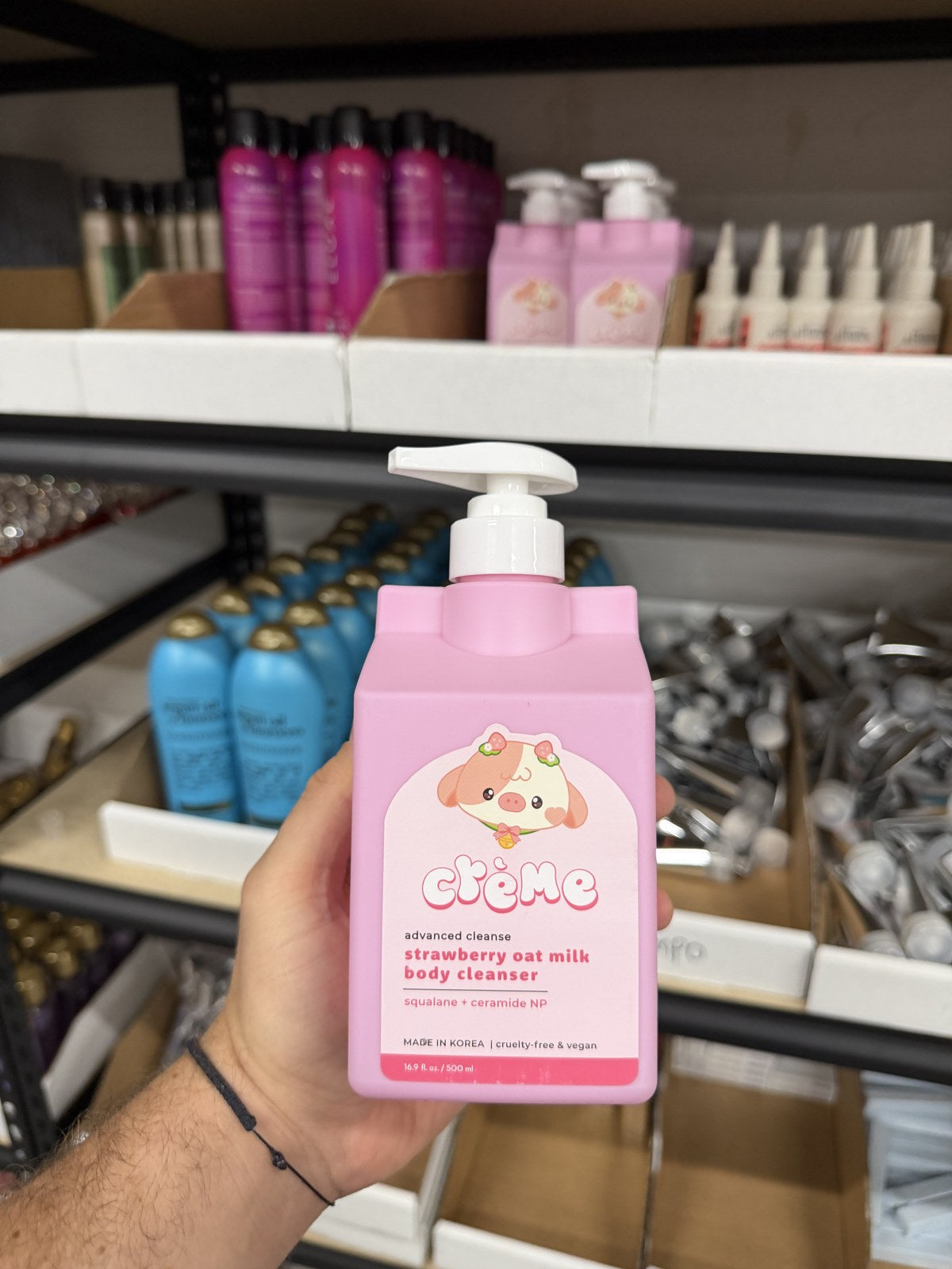 The Crème Shop strawberry body cleanser in hand