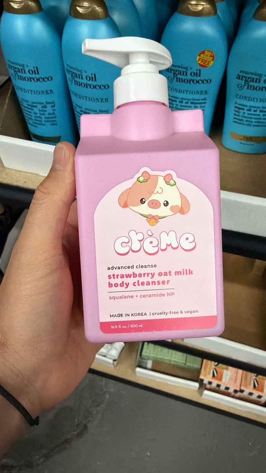 The Crème Shop strawberry body cleanser in hand, second view