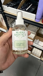 Mario Badescu Coconut Body Oil in hand, second view