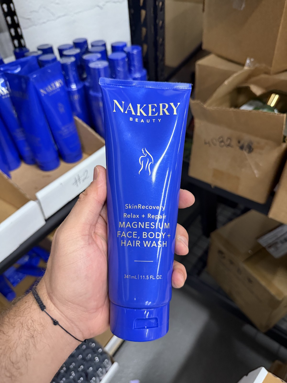 Nakery Beauty SkinRecovery Relax + Repair Magnesium Face, Body + Hair Wash 11.5 oz tube in hand