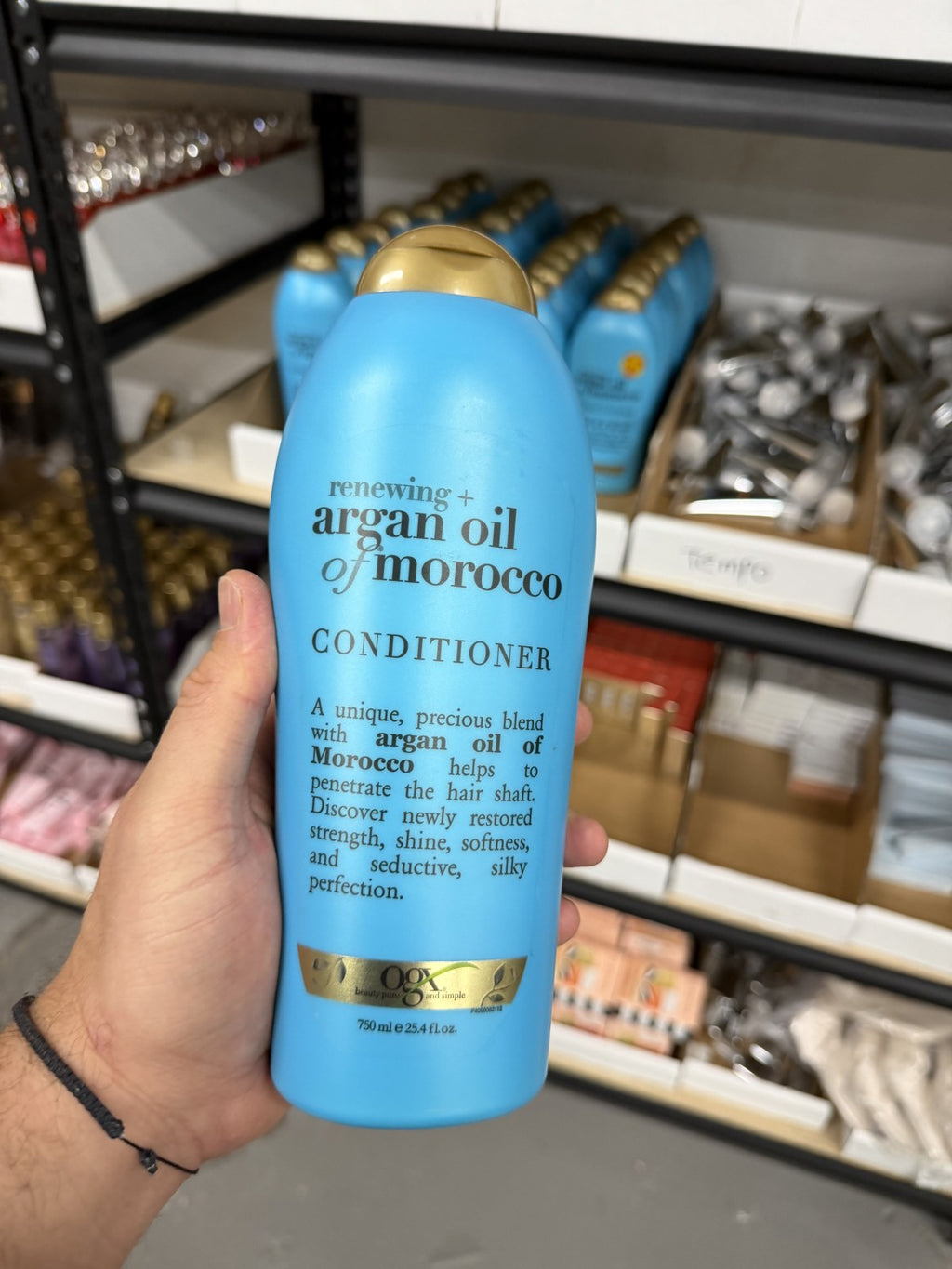 OGX Argan Oil Conditioner in hand