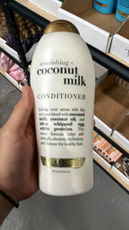 OGX Coconut Milk Conditioner in hand, second view